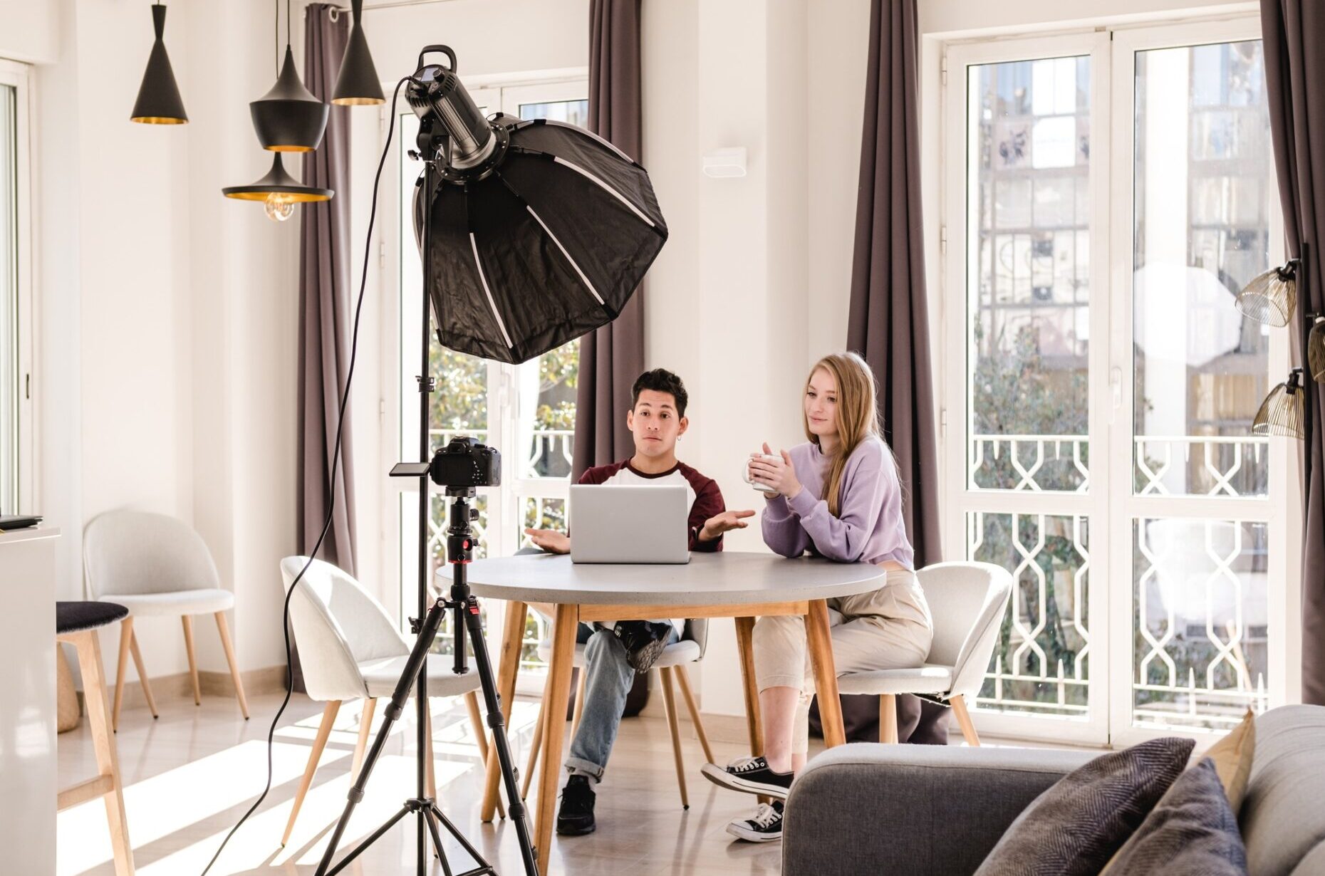 video bloggers making a video with a professional camera on a tripod at home. video bloggers making a video with a professional camera on a tripod at home.